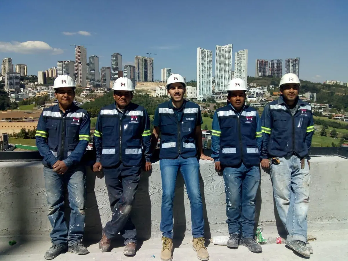 Equipo de LM Mantenimiento Profesional con casco y chaleco en una azotea de Interlomas